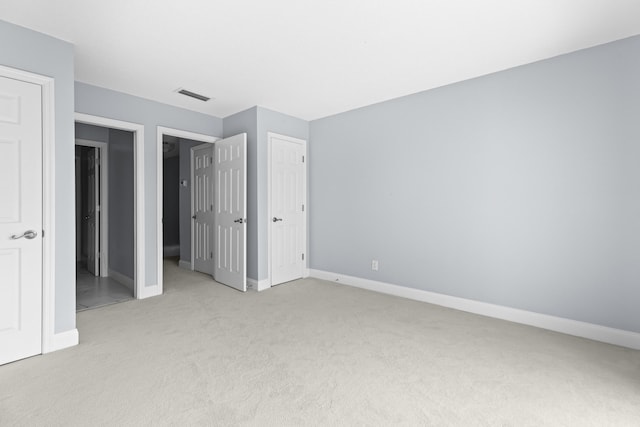 unfurnished bedroom with light colored carpet