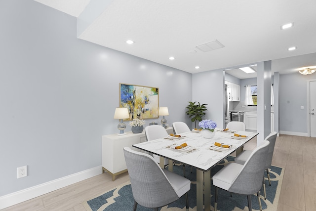 dining area with light hardwood / wood-style flooring