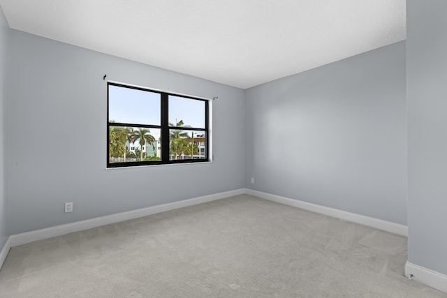 spare room featuring light colored carpet