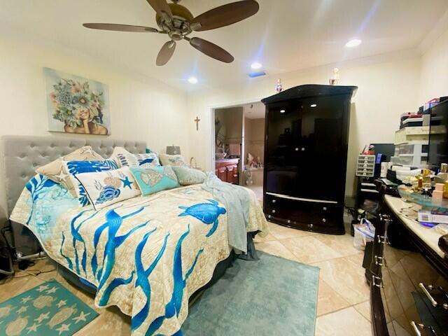 tiled bedroom featuring ceiling fan