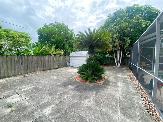 view of patio featuring a lanai