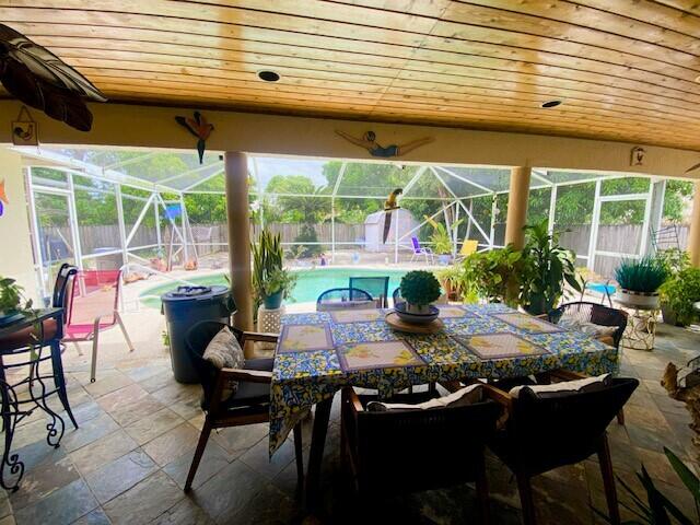 view of patio / terrace featuring a fenced in pool and a lanai