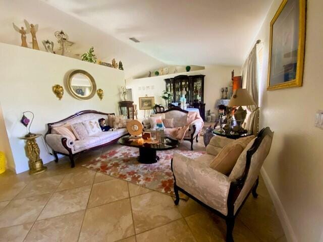 sitting room with light tile patterned floors and lofted ceiling