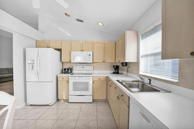 kitchen featuring sink, vaulted ceiling, white appliances, light brown cabinetry, and light tile patterned floors