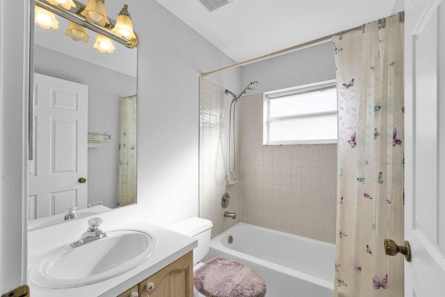 full bathroom featuring shower / bath combination with curtain, vanity, and toilet