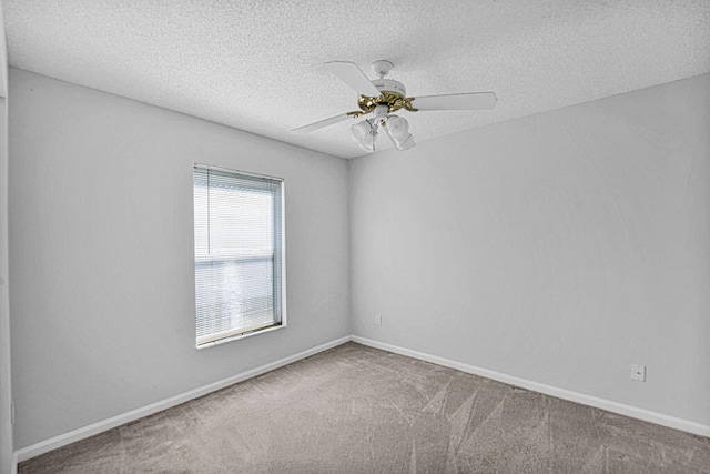 spare room with carpet flooring, ceiling fan, and a textured ceiling