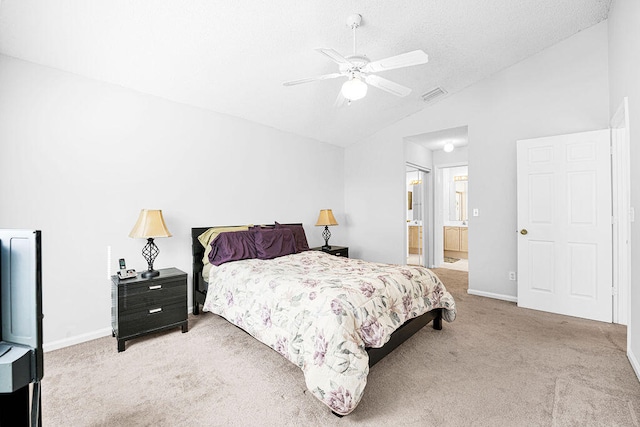 carpeted bedroom with ensuite bath, ceiling fan, and lofted ceiling