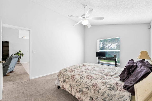 bedroom featuring a textured ceiling, light colored carpet, vaulted ceiling, and ceiling fan