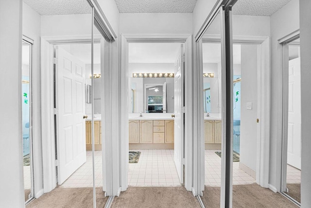 corridor featuring carpet floors and a textured ceiling