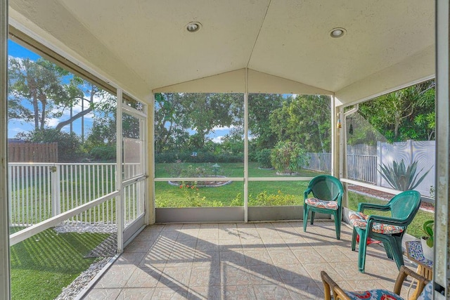 unfurnished sunroom with a healthy amount of sunlight and lofted ceiling