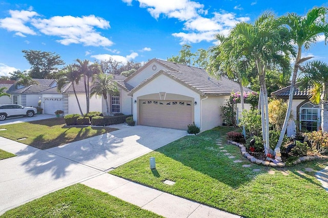 view of front of house with a garage and a front lawn