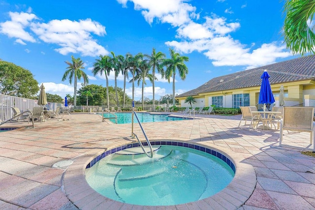 view of swimming pool with a patio and a hot tub