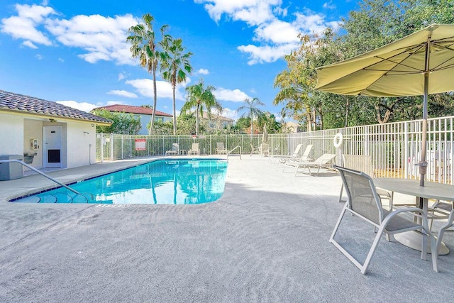 view of swimming pool featuring central air condition unit and a patio area