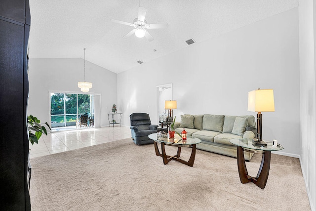 living room featuring ceiling fan, light tile patterned flooring, and lofted ceiling