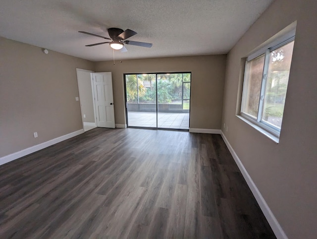 unfurnished room with ceiling fan, dark hardwood / wood-style flooring, and a textured ceiling