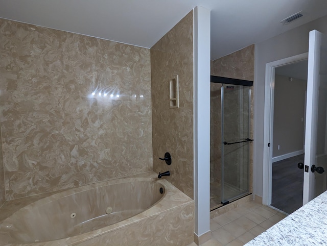 bathroom with tile patterned flooring and independent shower and bath