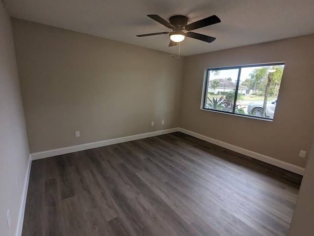 empty room featuring ceiling fan and dark hardwood / wood-style flooring