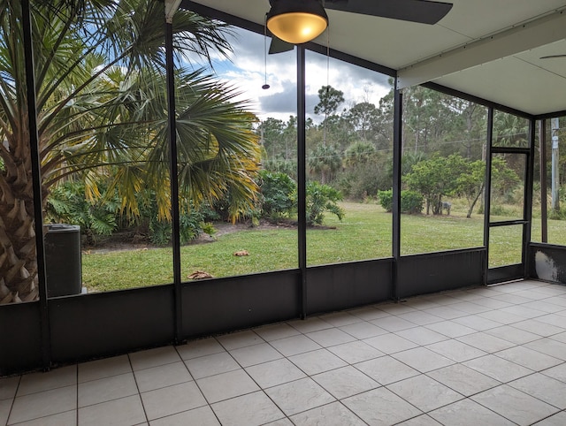 unfurnished sunroom featuring ceiling fan