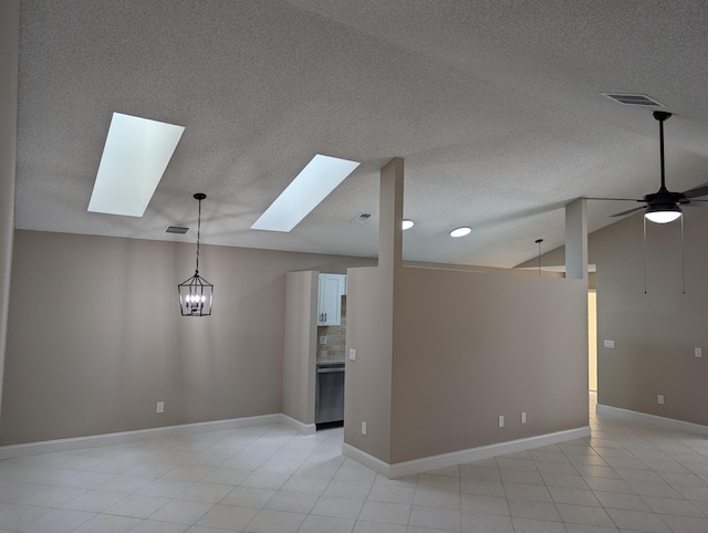 spare room with a textured ceiling, ceiling fan with notable chandelier, and vaulted ceiling