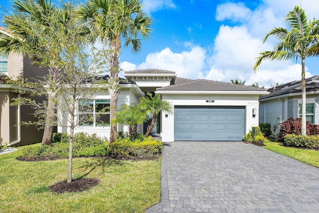 view of front of house with a front yard and a garage