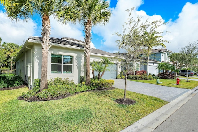 view of front of home featuring a garage and a front lawn