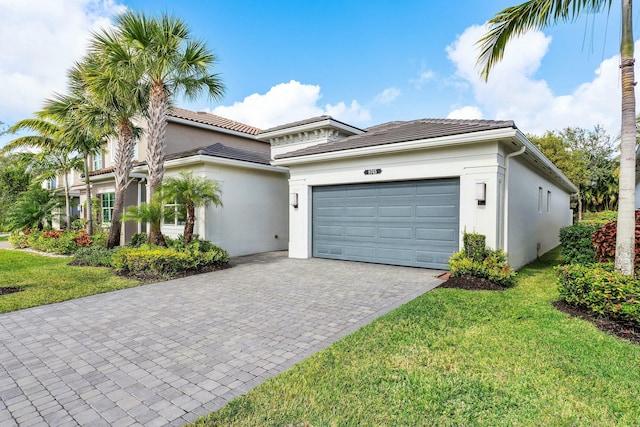 view of front of home featuring a front lawn and a garage