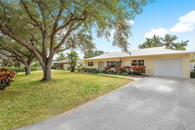 ranch-style house featuring a front lawn and a garage