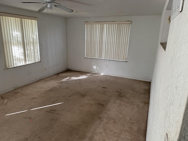 spare room with light carpet and ceiling fan