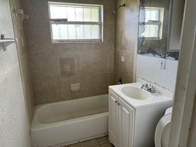 full bathroom with tile patterned flooring, vanity, toilet, and tiled shower / bath combo