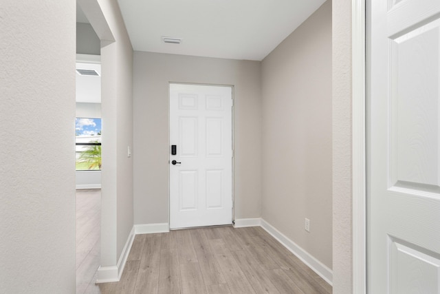 entrance foyer featuring light wood-type flooring, visible vents, and baseboards