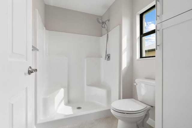 bathroom with toilet and walk in shower