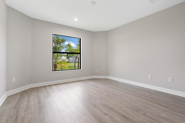 empty room featuring baseboards and wood finished floors