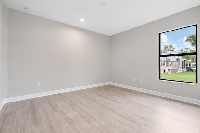 unfurnished room with light wood-style floors, recessed lighting, and baseboards