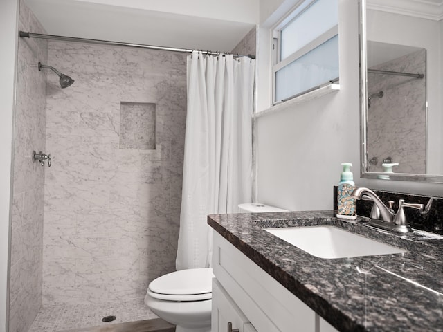 bathroom with crown molding, vanity, a shower with shower curtain, and toilet