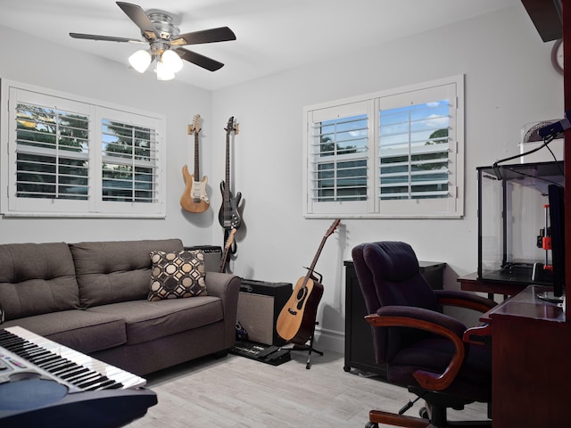 home office featuring light hardwood / wood-style flooring and ceiling fan