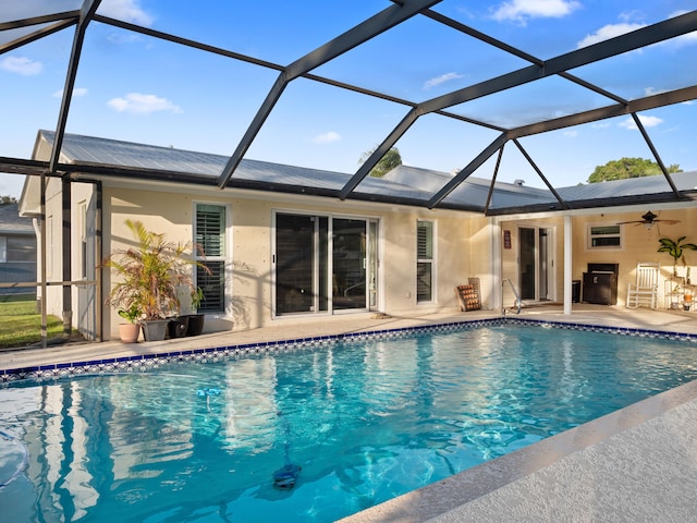 view of swimming pool featuring a lanai and a patio