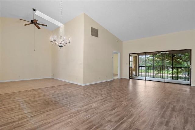 unfurnished living room with hardwood / wood-style floors, high vaulted ceiling, and ceiling fan with notable chandelier