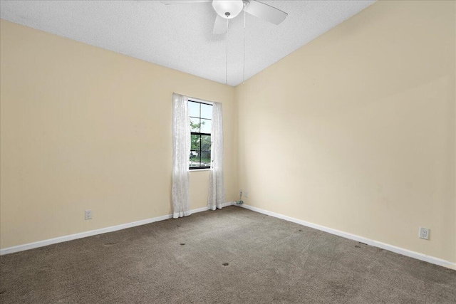 empty room with lofted ceiling, a textured ceiling, ceiling fan, and carpet