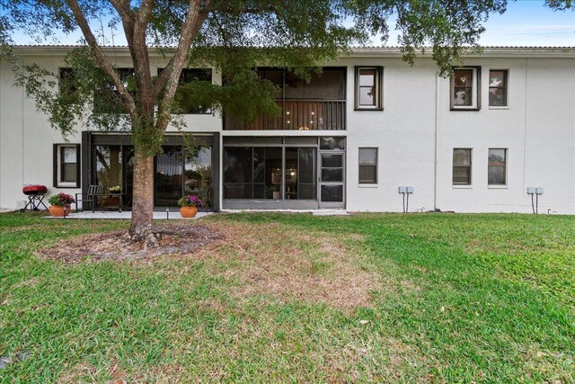 rear view of property with a yard