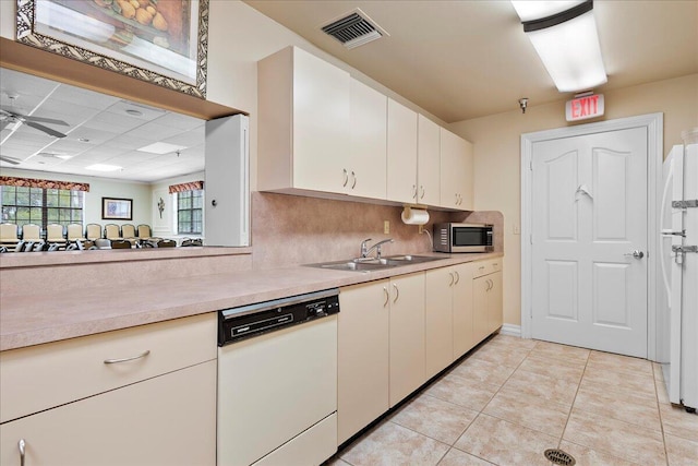 kitchen featuring white appliances, tasteful backsplash, light tile patterned flooring, ceiling fan, and sink