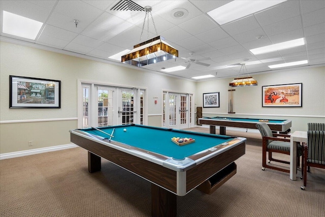 game room with pool table, light colored carpet, ceiling fan, french doors, and a drop ceiling