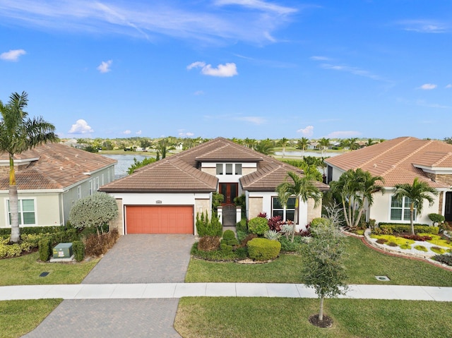 view of front of home featuring a front yard and a garage