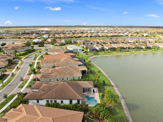 exterior space with a water view and a front lawn