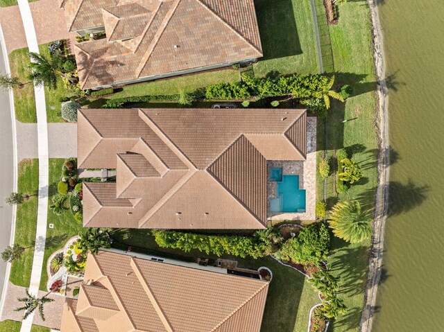 birds eye view of property with a water view