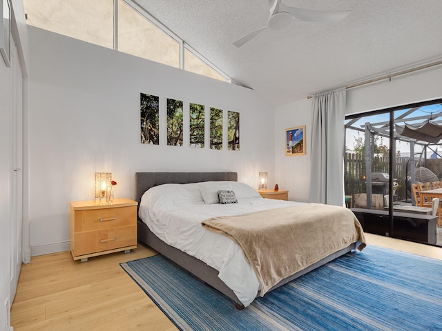 bedroom with hardwood / wood-style flooring, ceiling fan, a textured ceiling, and multiple windows