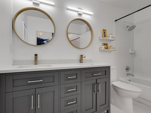 full bathroom with vanity, tiled shower / bath combo, and toilet