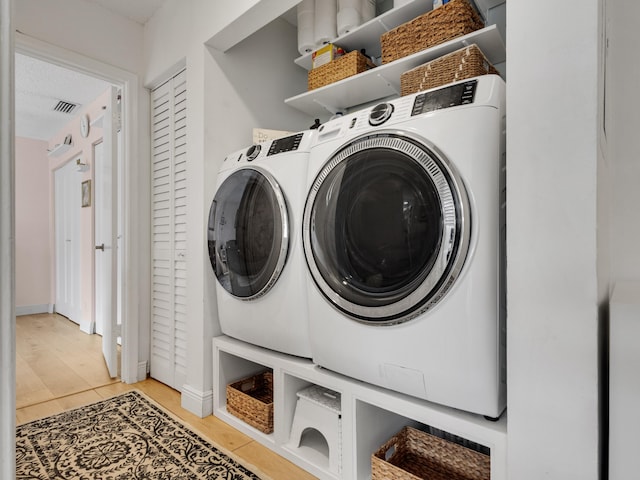 washroom with washer and clothes dryer and light tile patterned flooring