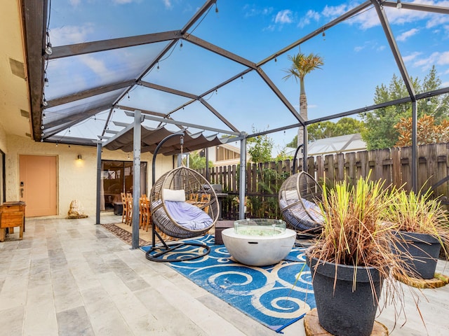 view of patio / terrace featuring glass enclosure