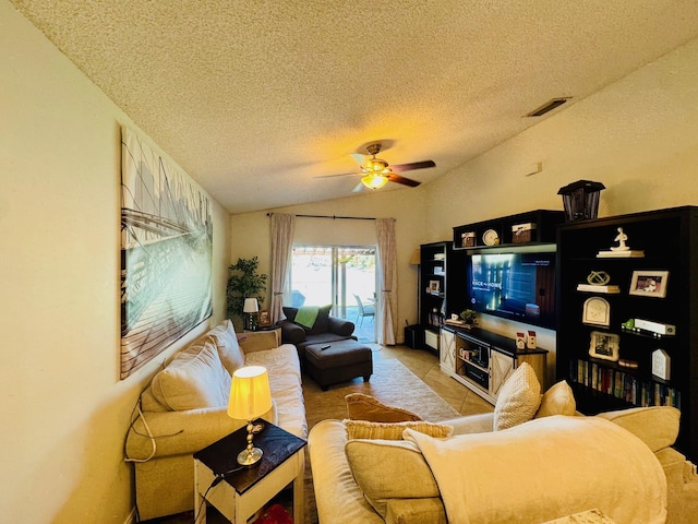 living room featuring ceiling fan, lofted ceiling, a textured ceiling, and light tile patterned floors