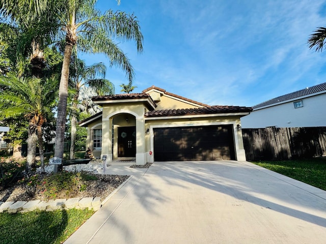 mediterranean / spanish house with a garage